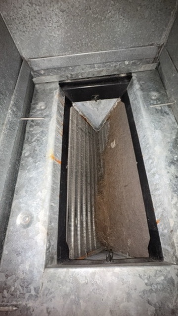 A dirty, dust-clogged evaporator coil before cleaning in a Niles, MI area home