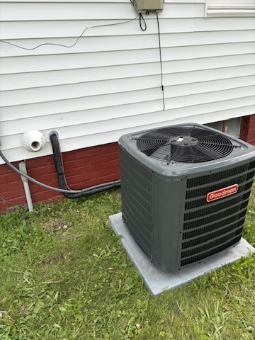 A Goodman AC condenser set on a new concrete pad at a Niles, MI area home