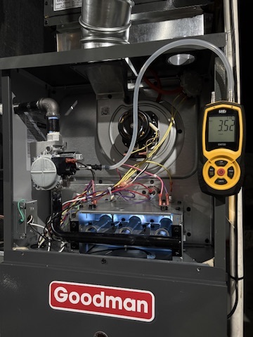 A technician running diagnostic tests on a Goodman furnace at a Niles, MI area home
