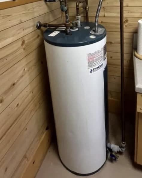 Old bulky tank water heater before replacement in a Niles, MI area home